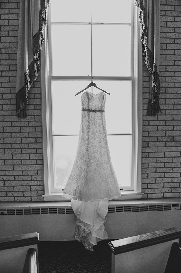 dress hanging on window at a church during a wedding cremonh