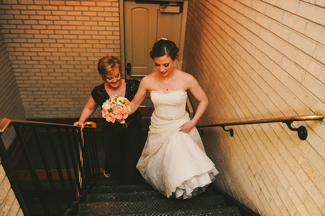 Mother and daughter walking up church steps on wedding day