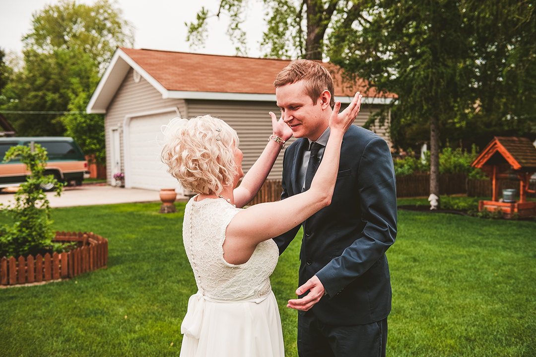 a groom reacting to seeing his bride for the first time during their first look