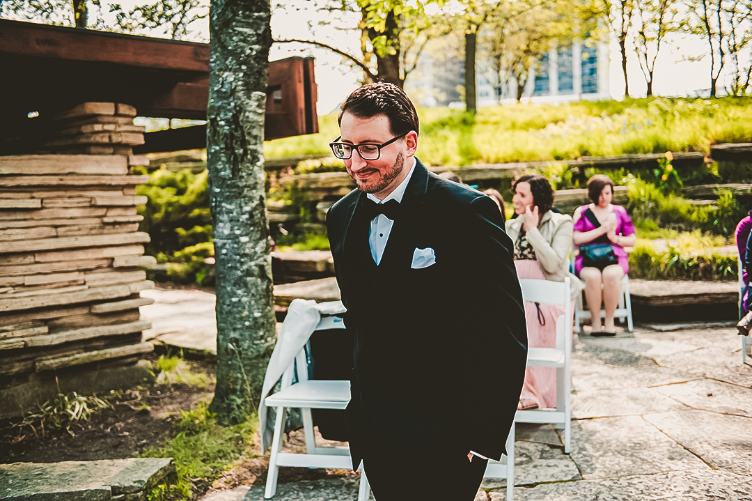 groom walking down path at the Chicago Lily Pond