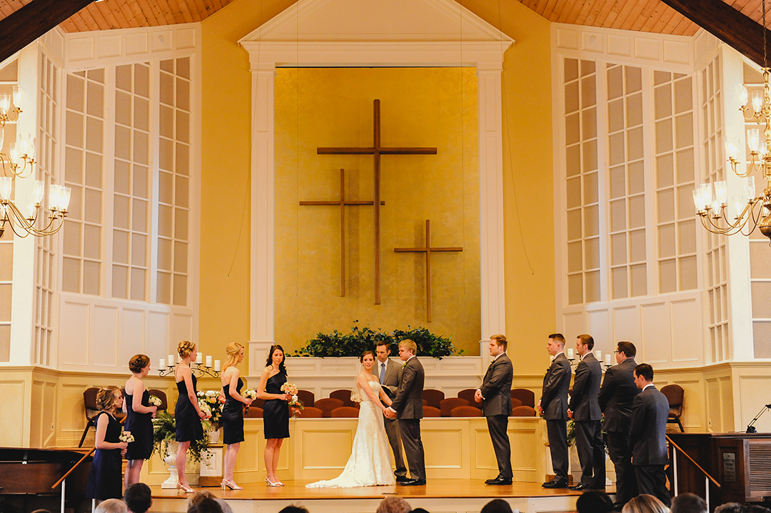 bridal party standing at alter during wedding ceremony