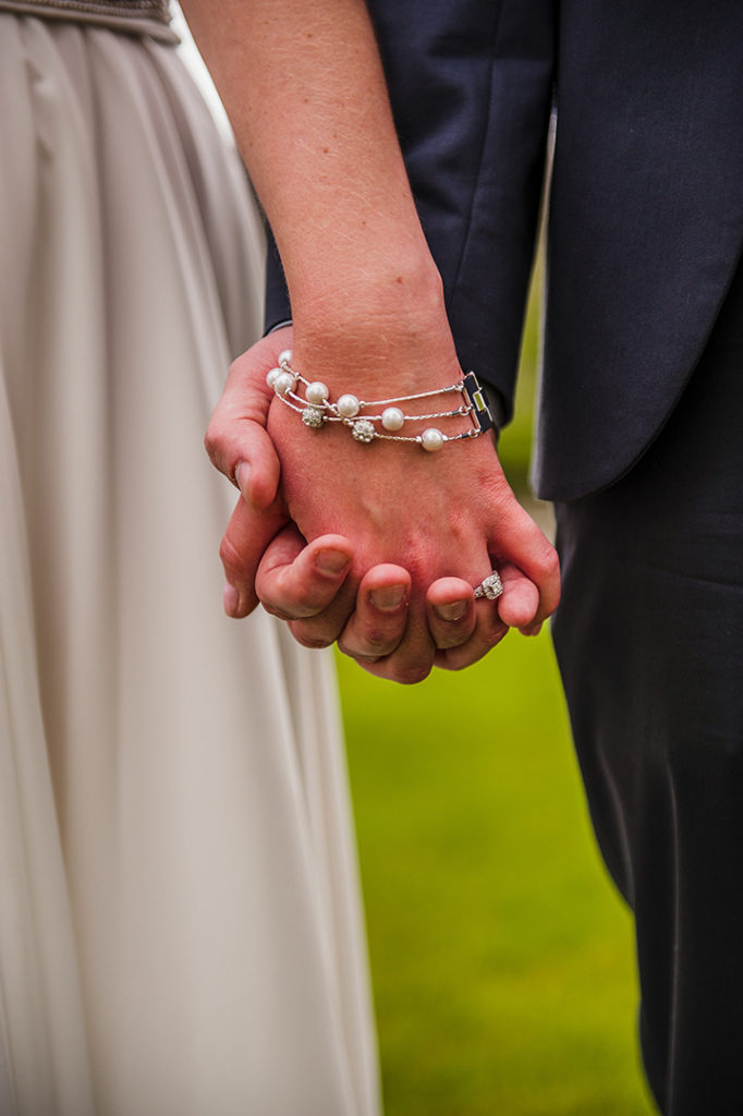a bride and groom holding hands at a Naperville hotel
