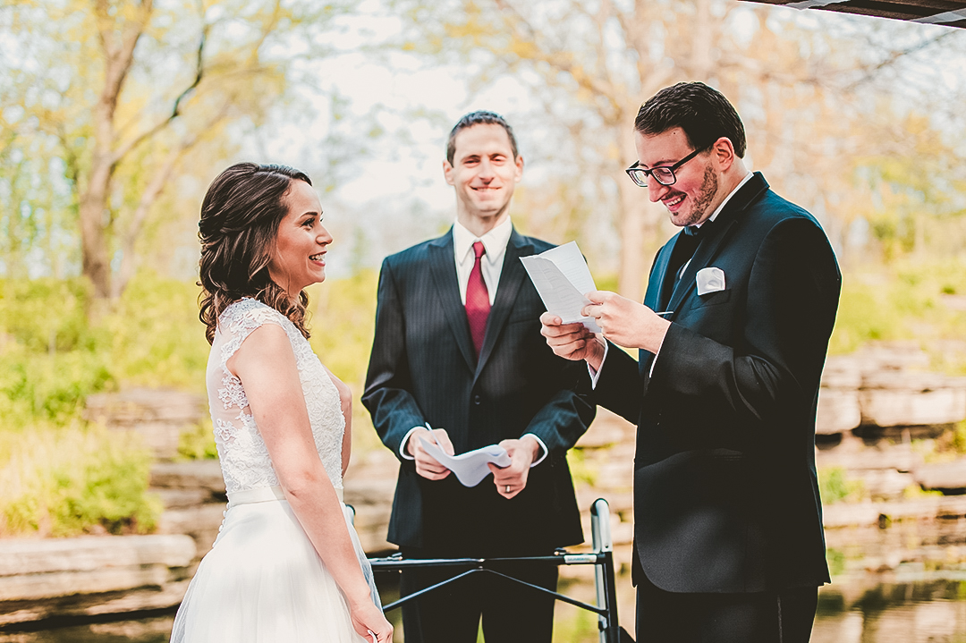 groom reading his bride his vows during ceremony