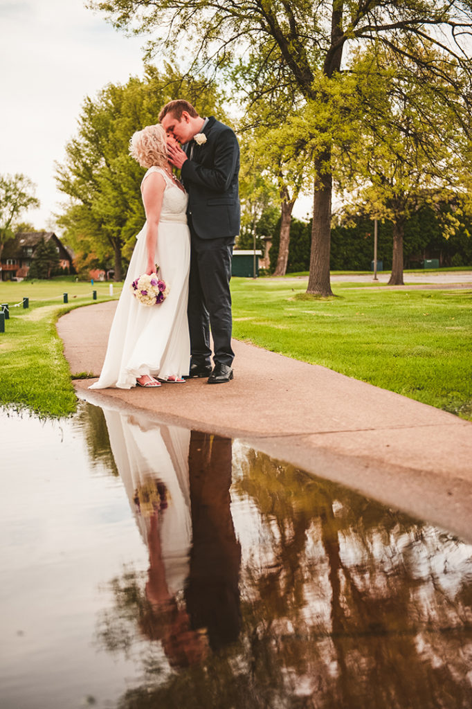 groom kissing bride at the Naperville Country Club