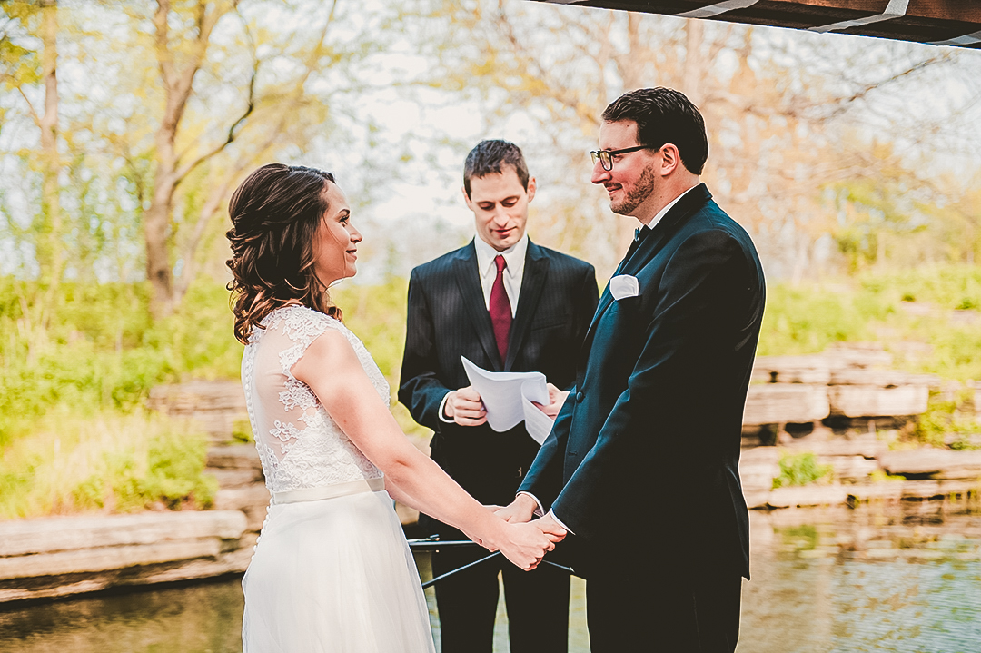bride and groom holding hands at the Alfred Caldwell Lily Pond