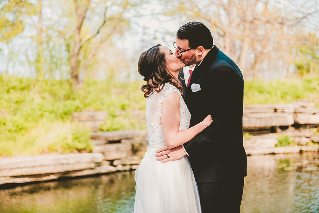 bride and groom experiencing their first kiss at the Chicago Lily Pond
