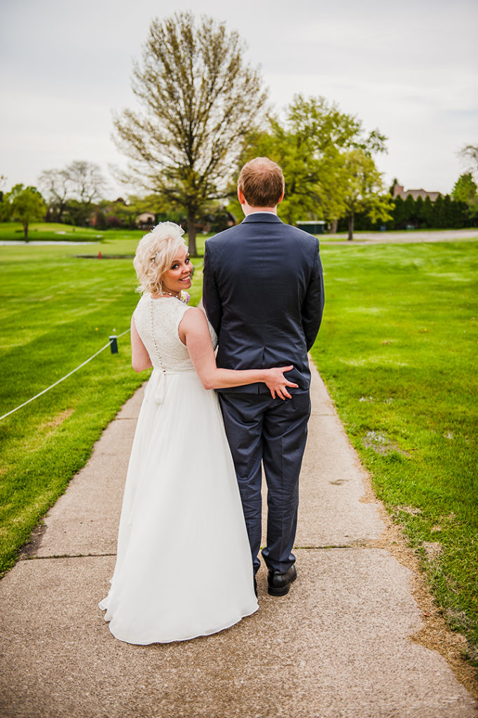 a bride grabbing her grooms butt on gold course