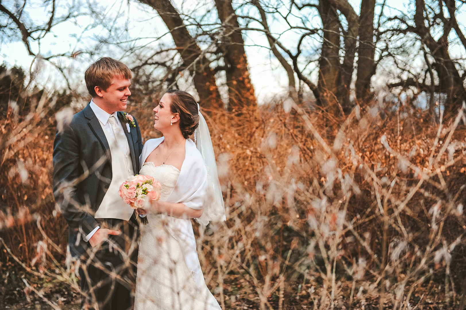 a wedding couple amongst the grass at the Morton Arboretum