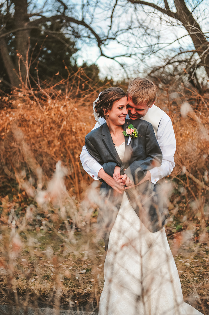 a wedding couple snuggling in the woods and the Morton Arboretum in Lisle