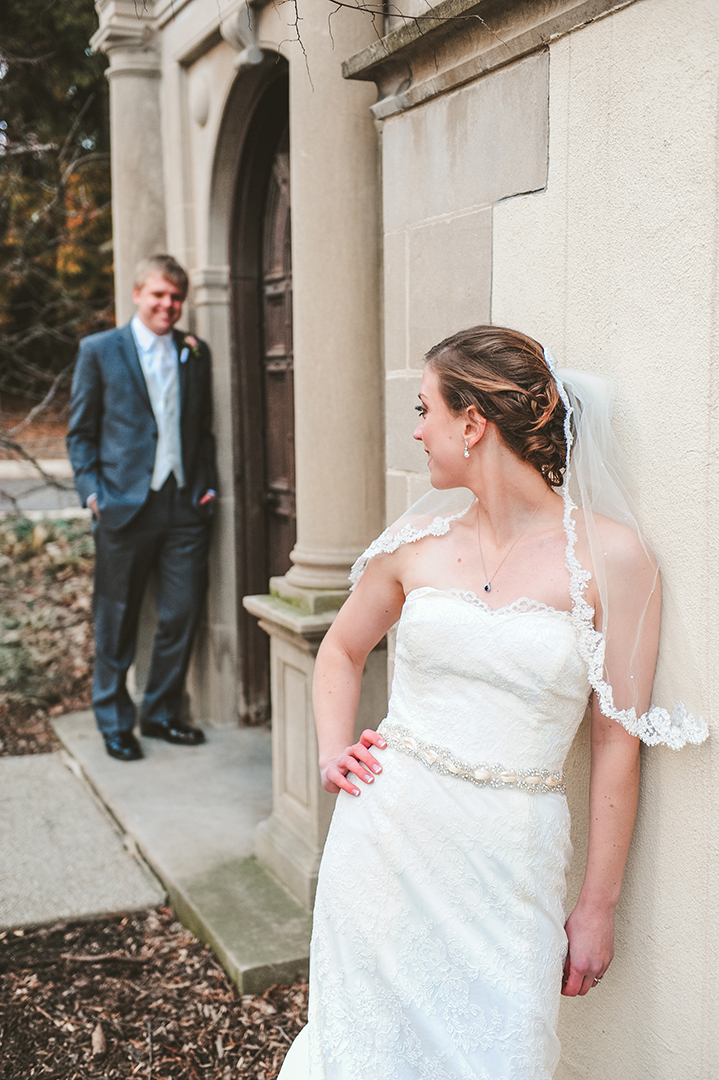 a bride looking at her groom in the cold fall weather