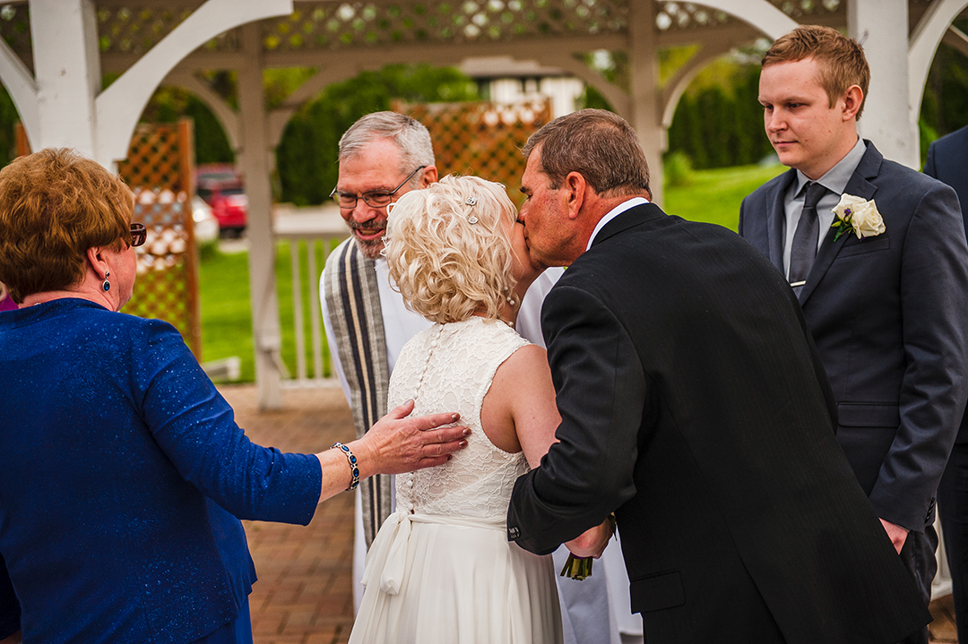 bride kissing her father at wedding