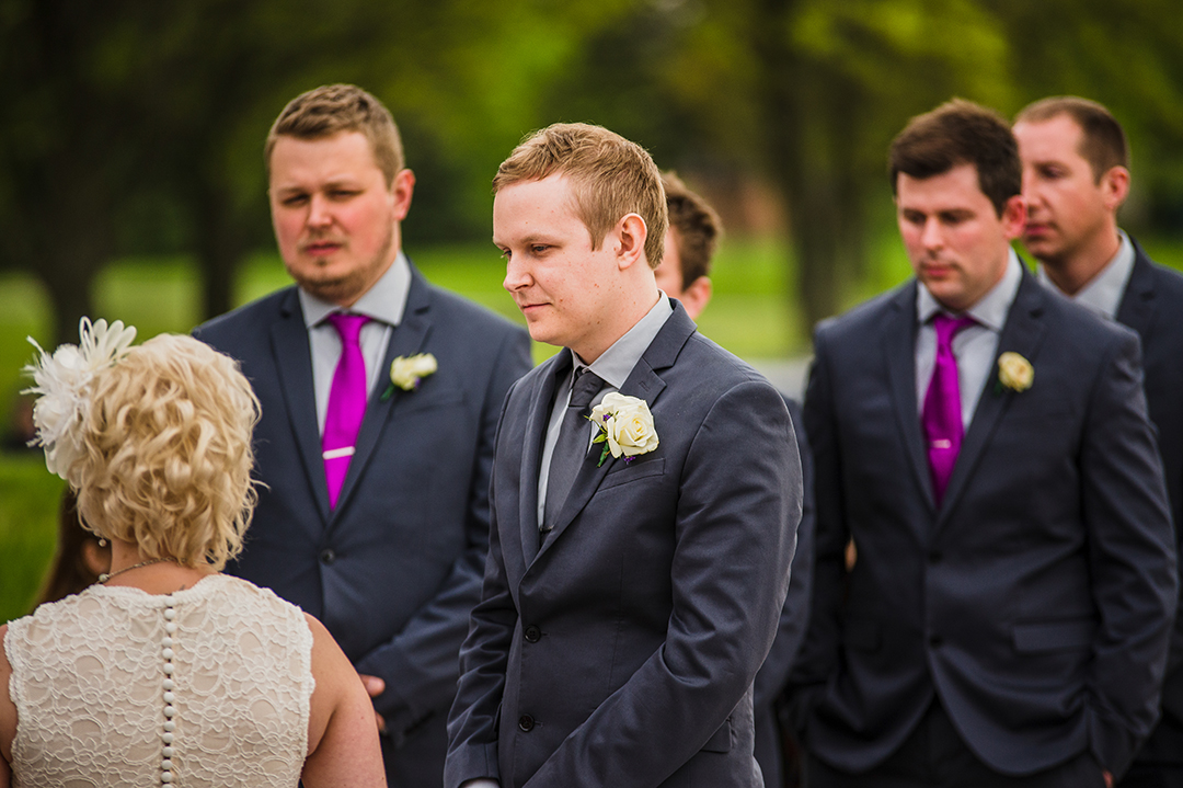 groom looking at his bride during wedding ceremony 