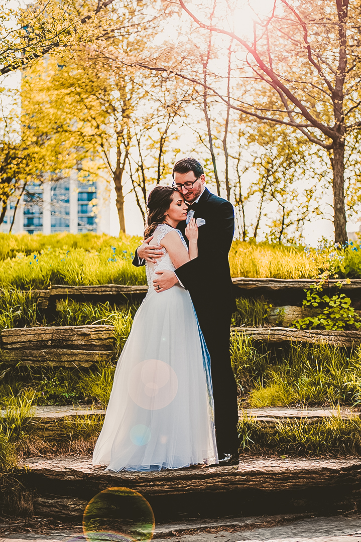 husband and wife snuggling together at Alfred Caldwell Lily Pond