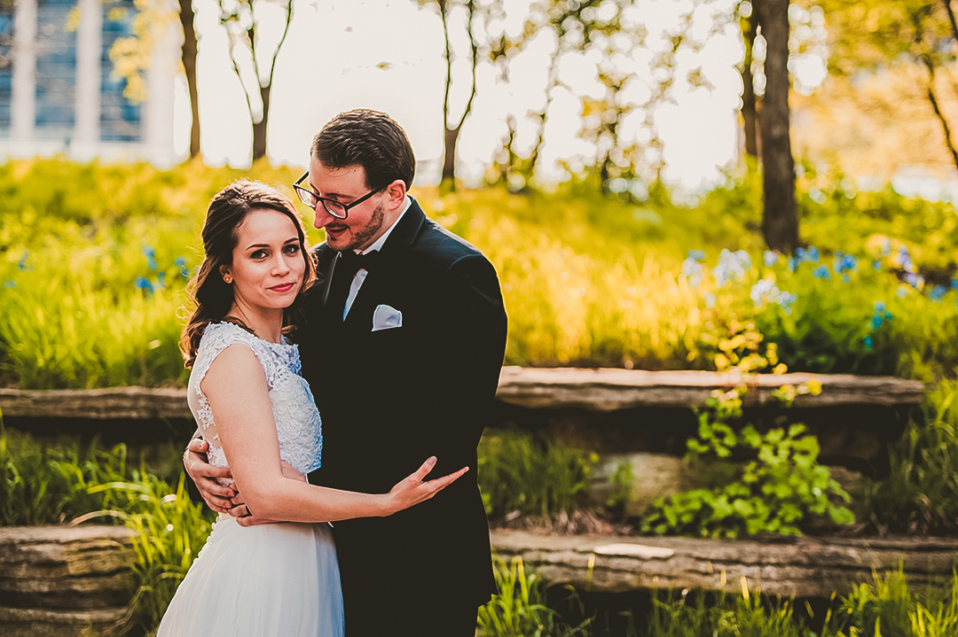 groom looking at his bride with his arms around her