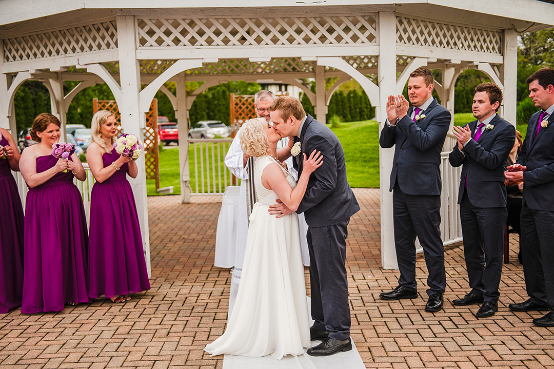 a bride and groom experiencing their first kiss as husband and wife