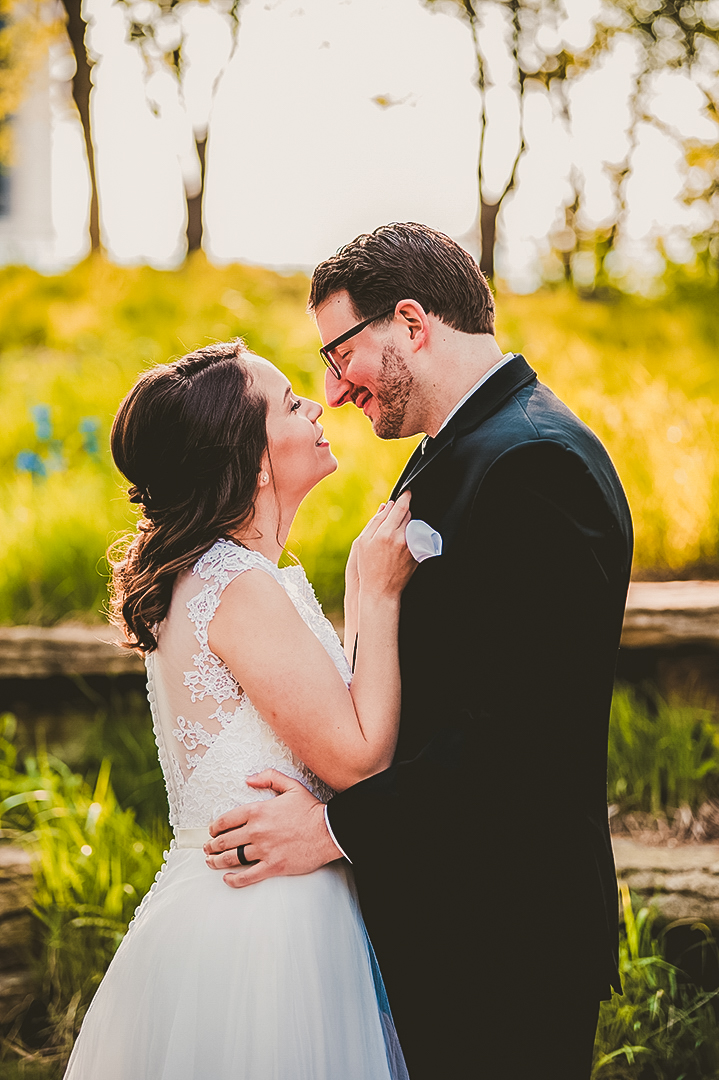 wife pulling her groom close for a kiss