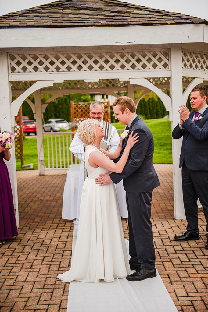moments after a bride and grooms first kiss at wedding ceremony