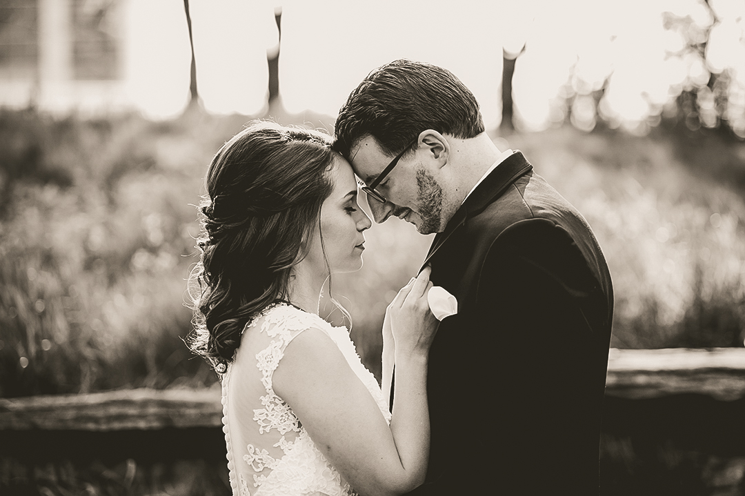 bride and groom passionately standing with their heads together