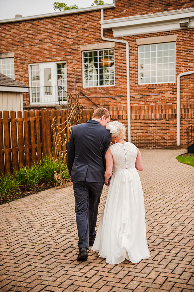 bride and groom closely holding hands after wedding ceremony