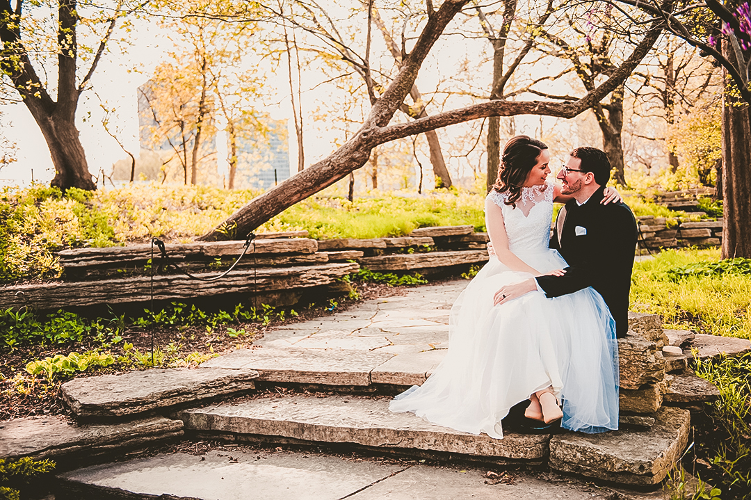 bride sitting on her husbands lap at the Chicago Lily Pond