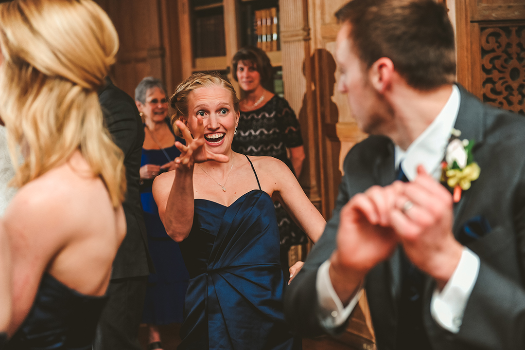 a woman doing something funny while dancing at a wedding reception