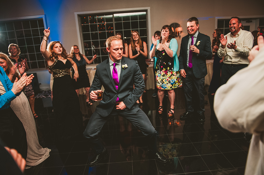 groomsman dancing with group at Naperville wedding reception