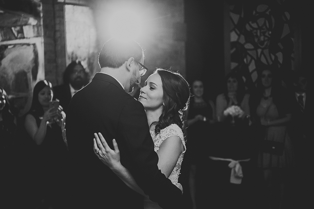newlyweds dancing their first dance at Chicago art gallery