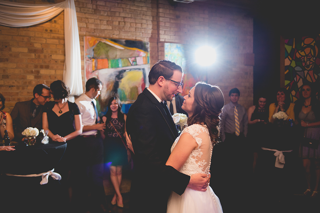 friends of newlyweds watching at they experience their first dance