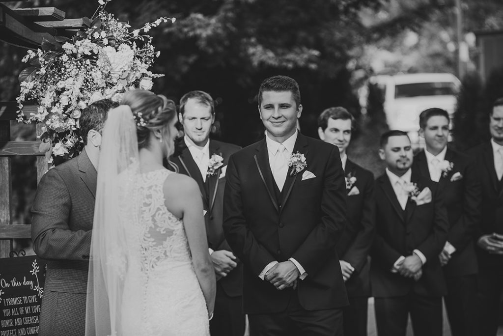 A groom smiling at his bride during their Naperville wedding.