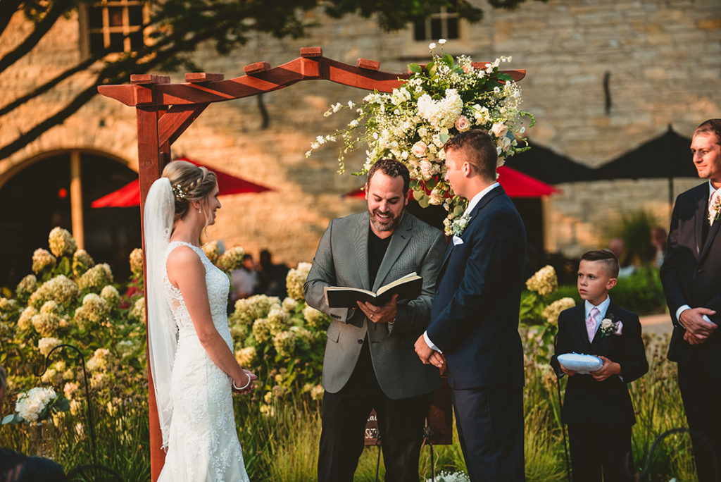 A bride and groom looking at their pastor during their Naperville wedding.