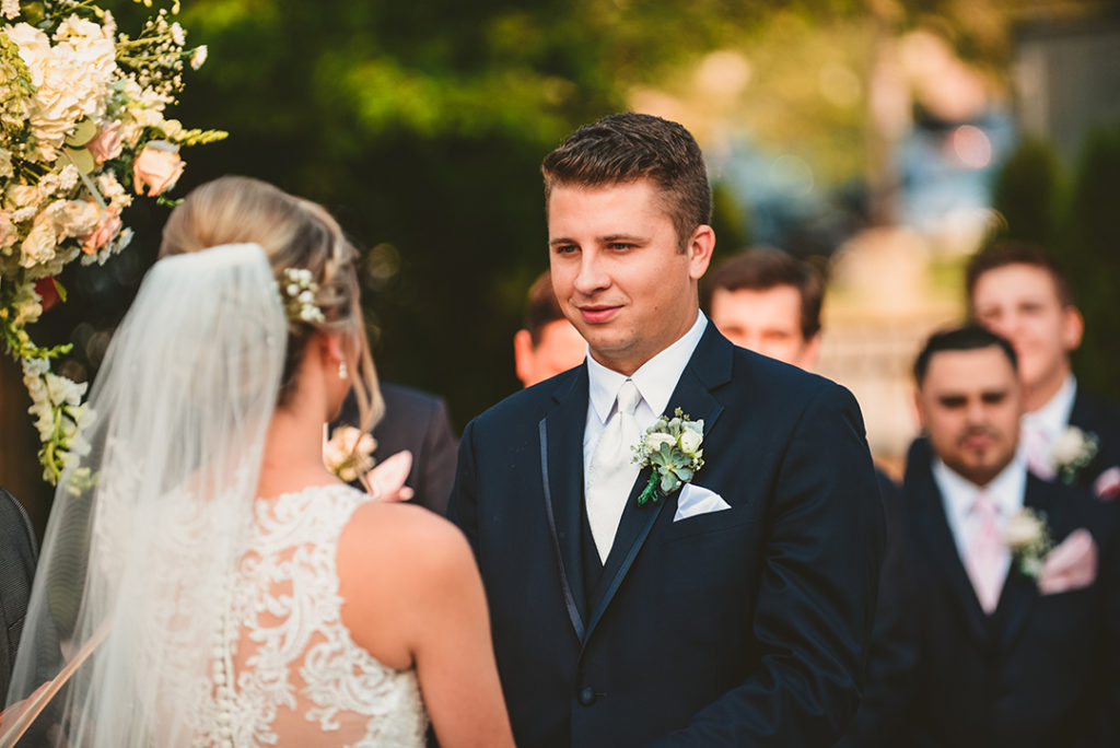 A groom looks at his bride during their wedding in Naperville.