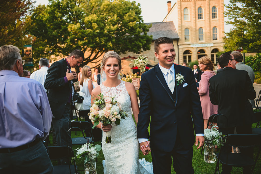 A bride and groom laughing with excitement at the Public Landing in Lockport.