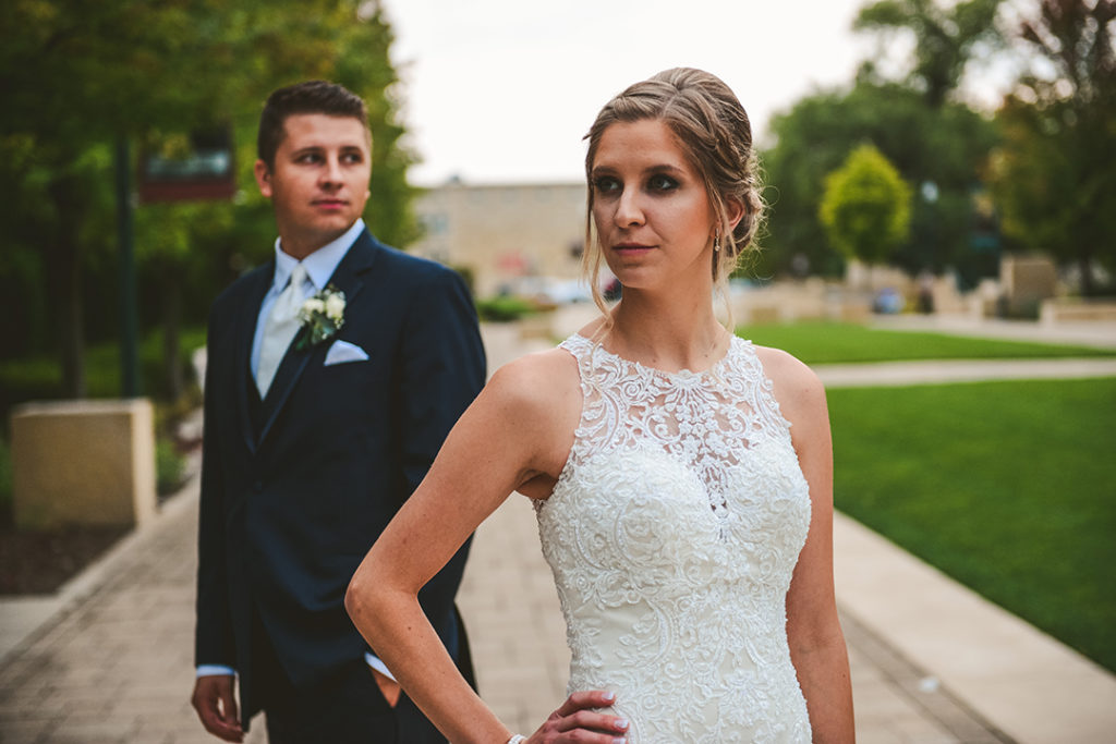 A beautiful bride stands in front of her groom at a Naperville wedding.