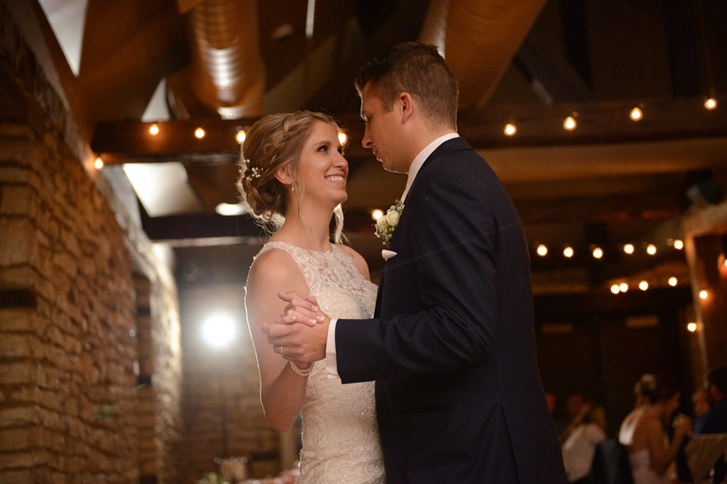 A bride and groom smiling at each other while dancing at the Public Landing in Lockport.