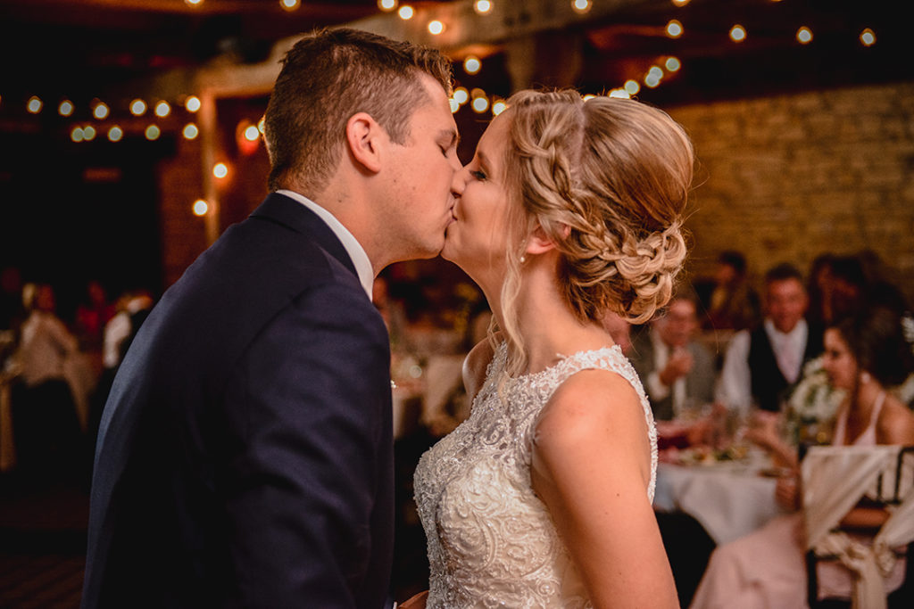 A bride and groom kissing after their first dance at the Public Landing in Lockport.