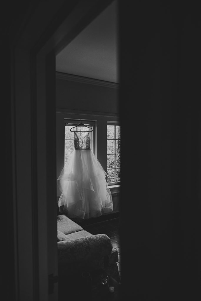 wedding dress hanging in a room at a Cheney Mansion Wedding