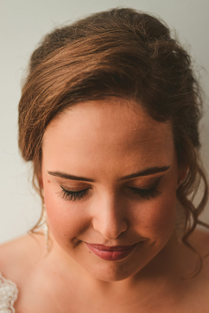 detail image of a brides eyelashes as she smiles