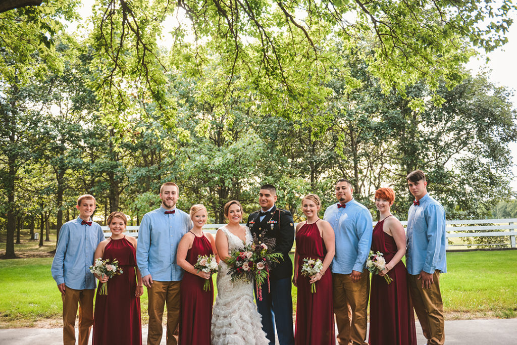 a full bridal party standing with the bride and groom at a Olympia Fields wedding