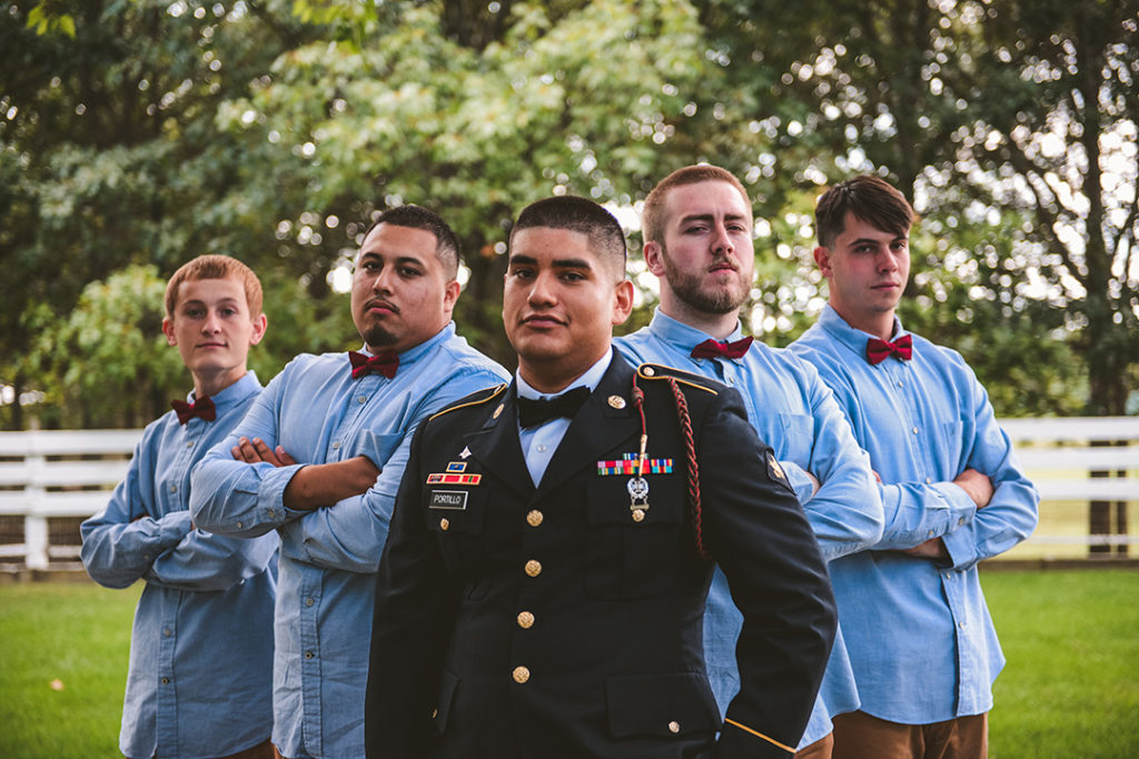 a group of groomsmen standing serious with the groom at a Olympia Fields wedding