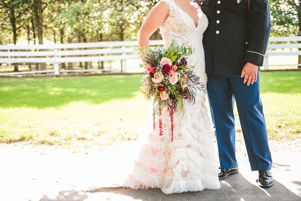 a real flower bouquet next to the grooms marine uniform