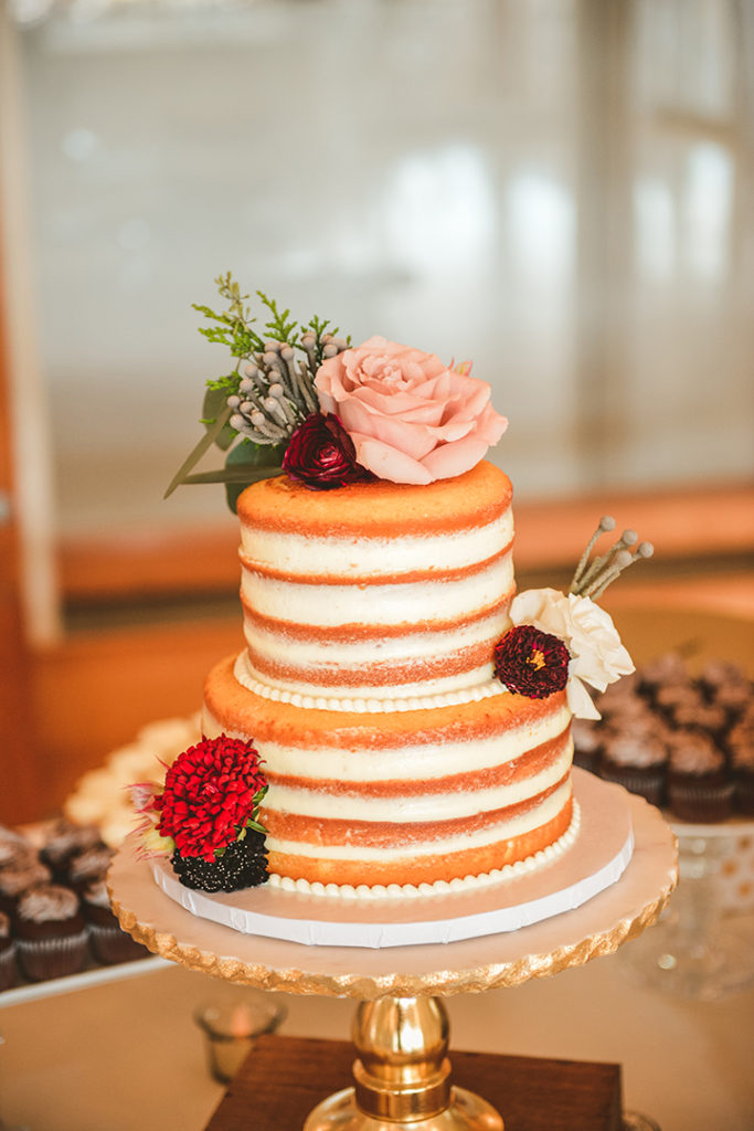 a naked wedding cake with real flowers at a Olympia Fields wedding reception