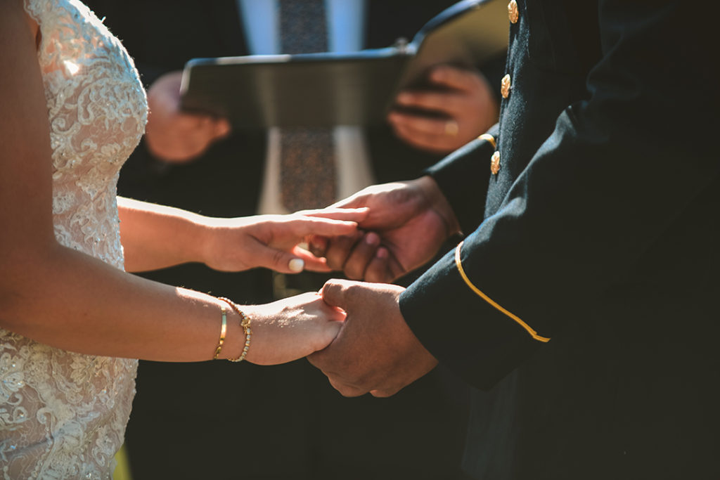 a closeup of a bride and groom holding hands during a wedding ceremony in Olympia Fields