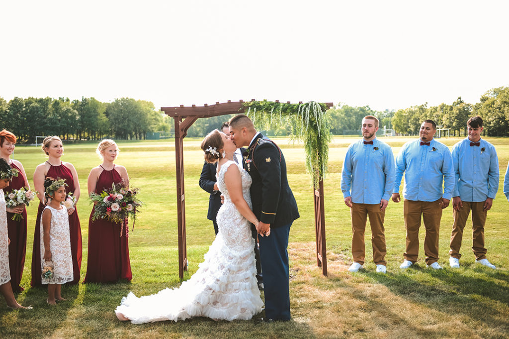 newlyweds kissing for the first time at a outdoor Olympia Fields wedding