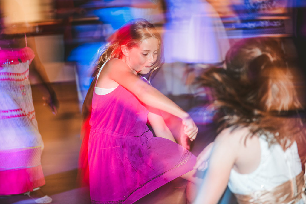 a little girl dancing in a pink dress at a Olympia Fields wedding reception