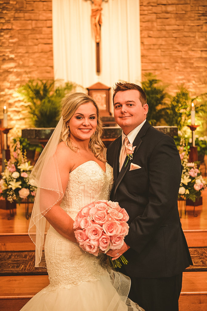 the bride and groom standing with each other after getting married at their family church