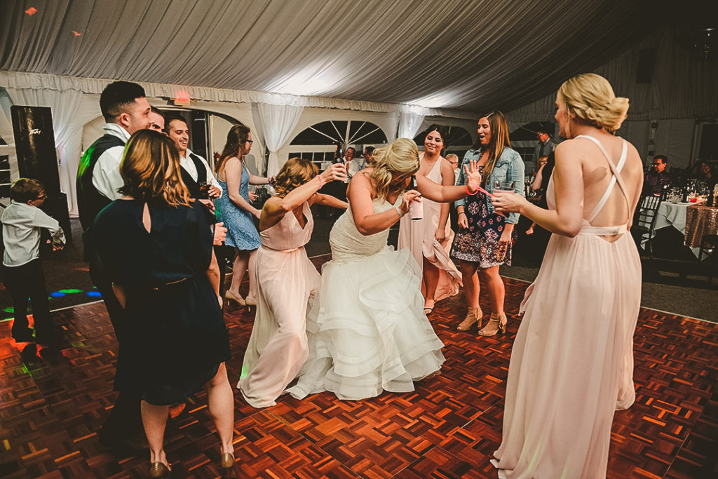 the bride bumping and grinding on her made of honor at her wedding reception