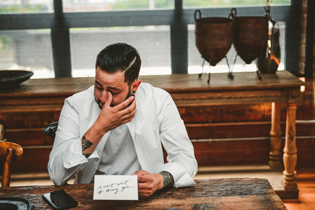 man tearing up after reading a note from his wife at a Pittsburg Pennsylvania wedding