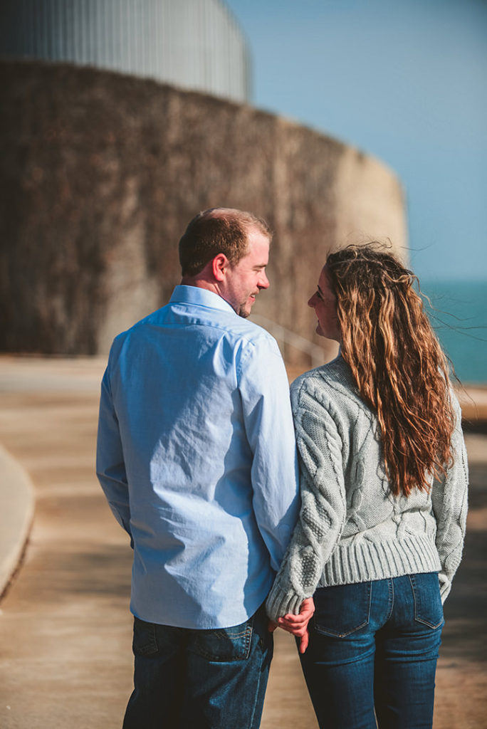 a man and woman walking down a path by the Chicago lakefront