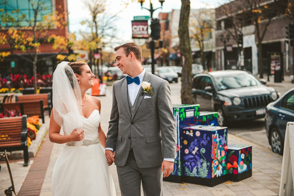 a good looking couple walking down the city streets of Elmhurst