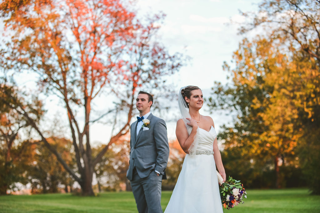 the setting sun with a bride and groom looking off into the distance